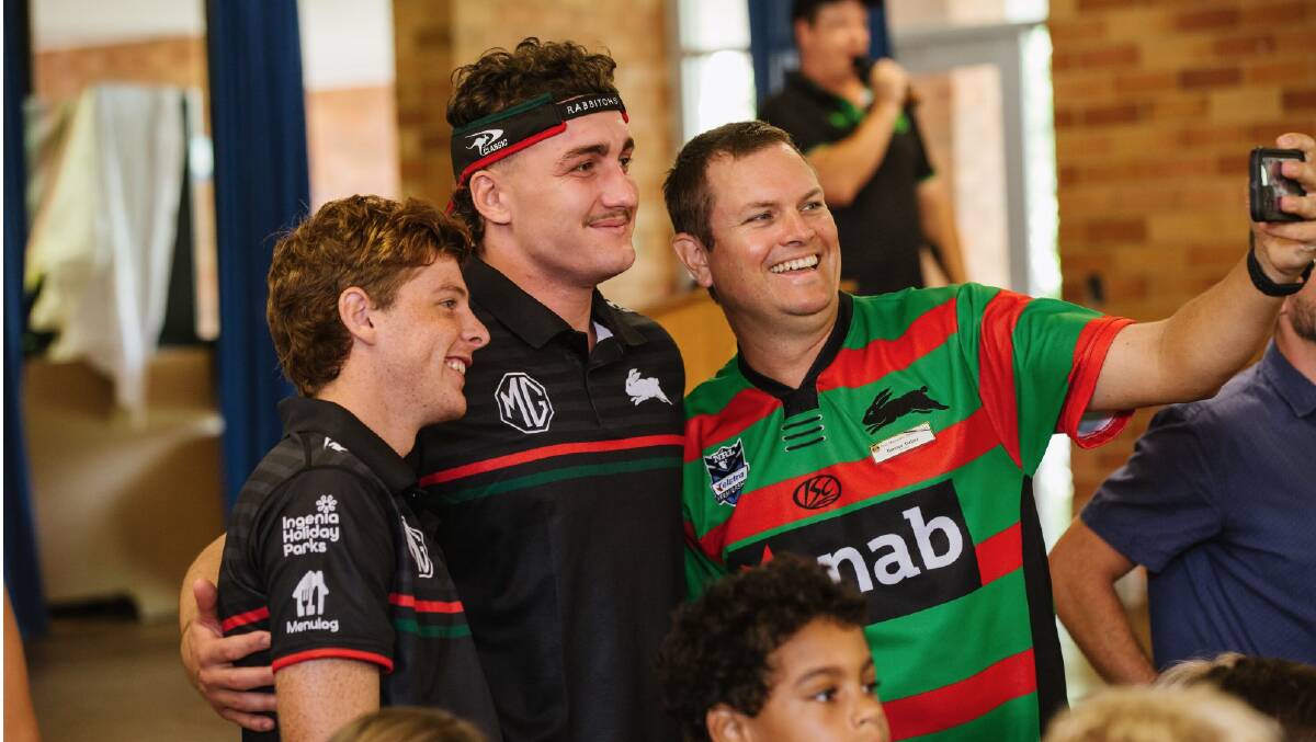 Ben Lovett takes a photo with two South Sydney fans. Picture supplied