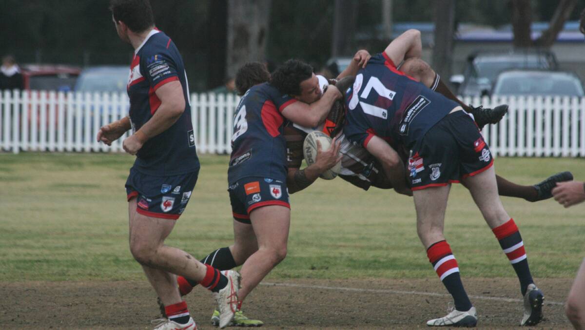 Gilgandra youngster Isaiah Gleadhill is tackled by two Cobar Roosters on the weekend. Picture by Stephen Basham