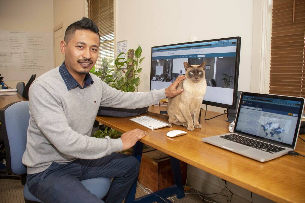 iClick2Learn staff member Digaj Basukala with Sheba in the company's Dubbo office. Picture by Belinda Soole
