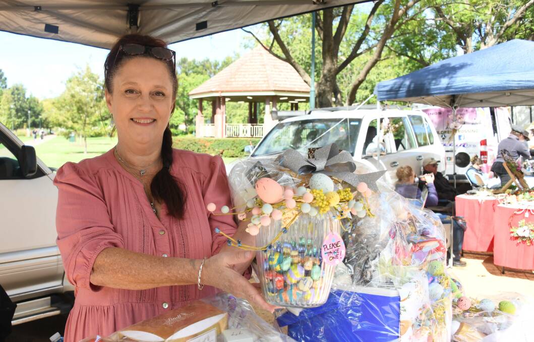 Danielle King at the Rotunda Markets with the hampers on offer in her fundraising raffle for the Cancer Council. Picture by Amy McIntyre