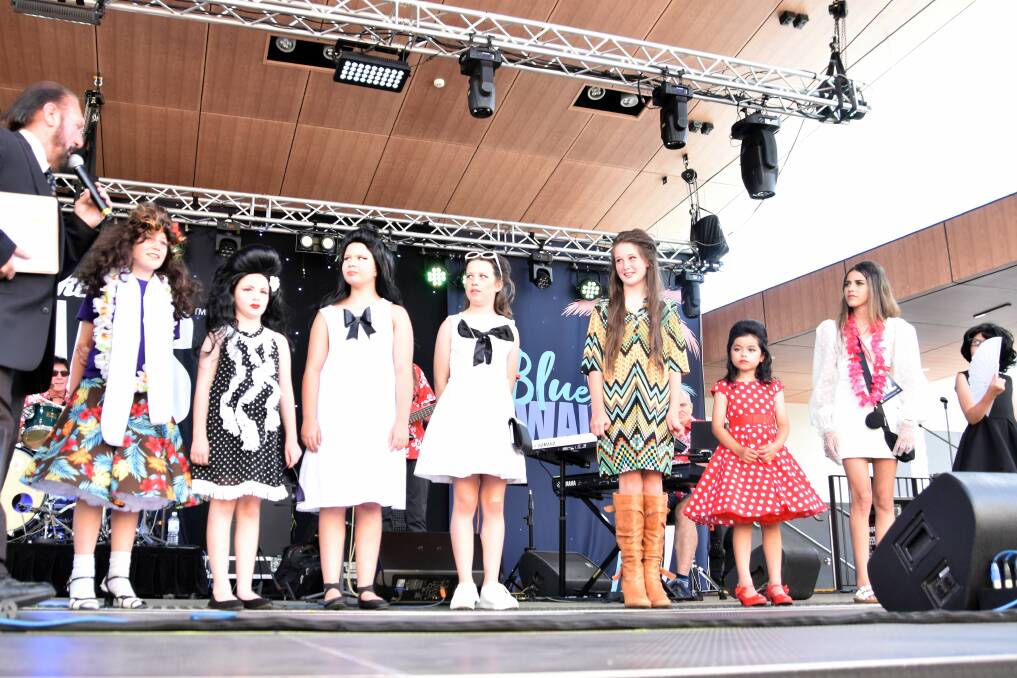 Izzy (third from the left) lines up on stage with other Junior Priscilla look-a-like contenders. Picture by Jenny Kingham