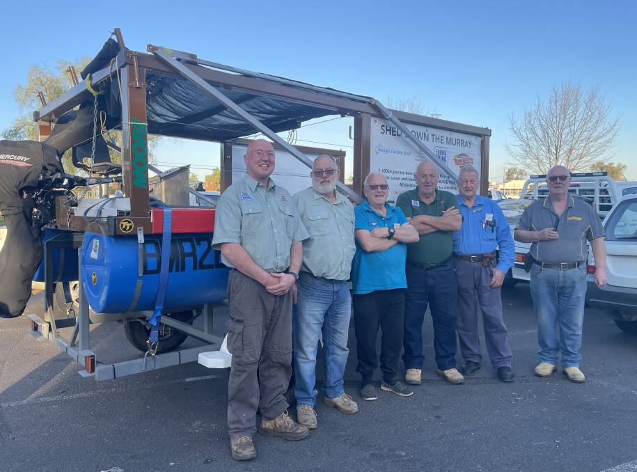Members of the Dubbo Men's Shed with members of the Pittsworth and District Men's Shed and their river raft. Picture by Allison Hore
