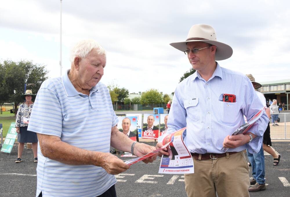 Dubbo Labor candidate Josh Black (right) hands out 'how to vote' cards on election day. Picture by Amy McIntyre