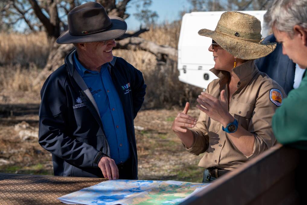 Dr Simon Banks and New South Wales National Parks and Wildlife Service (NPWS) staff view a map of the Macquarie Marshes during their visit yesterday. Picture supplied