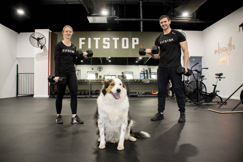 PAWESOME: FitStop owners Rachel Ferdinand and Craig Anderson with Parker. Picture: Belinda Soole