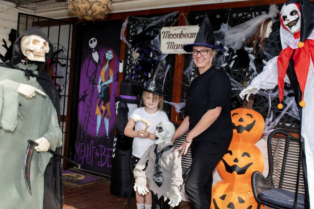 Aria and Tara Gillett outside their very spooky home. Picture by Belinda Soole