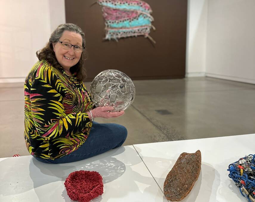 Parkes-based Wiradjuri artist Ronda Sharpe with one of her artworks in the Interwoven Connections. Picture supplied