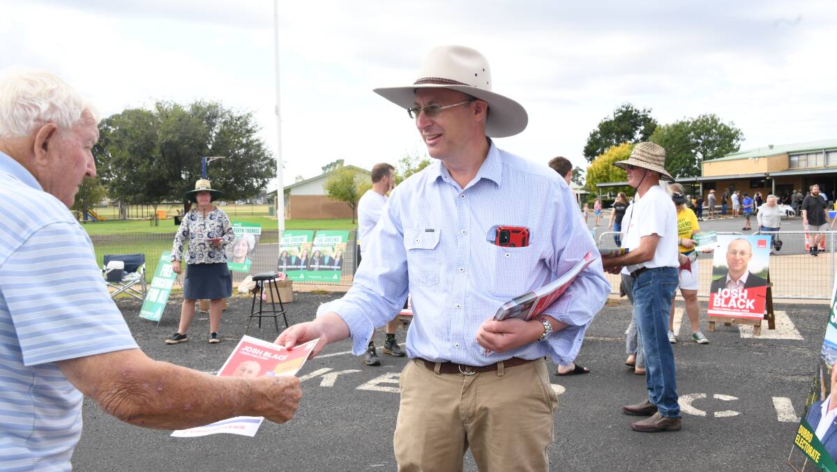 Dubbo Labor candidate Josh Black hands out 'how to votes' on election day. Picture by Amy McIntyre
