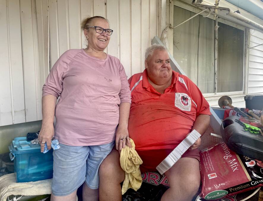 Gidley Street residents Elizabeth and Anthony "Bruno" Bennett doing their best to stay in good spirits after Molong's Monday flooding tore through their property. Picture by Emily Gobourg.