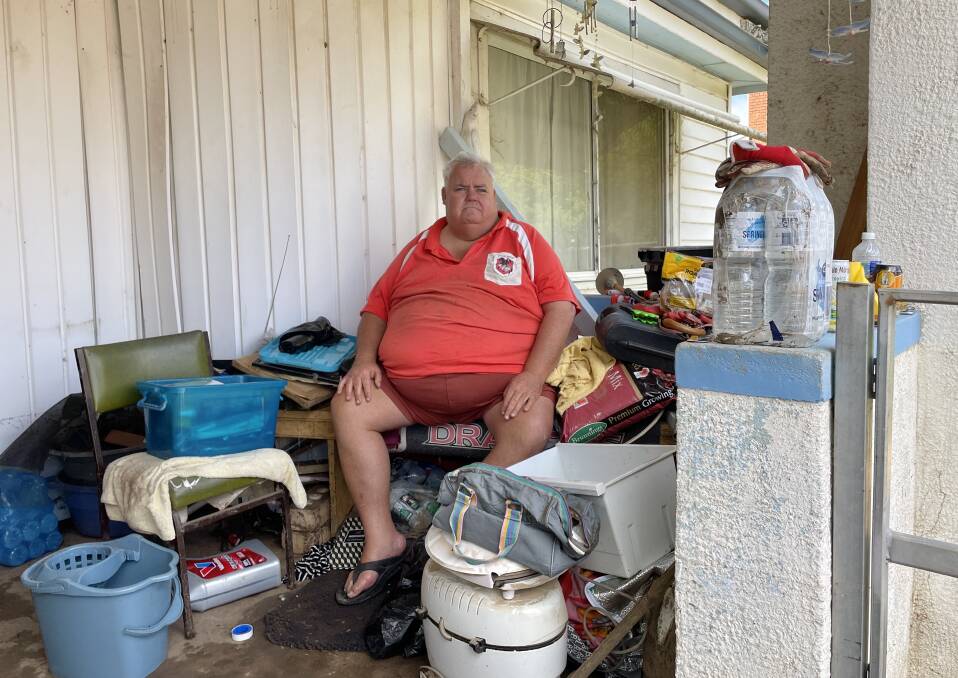 While cleaning off flood-damaged household items, Anthony "Bruno" Bennett felt for the people in Molong who "got it a lot worse". Picture by Emily Gobourg.