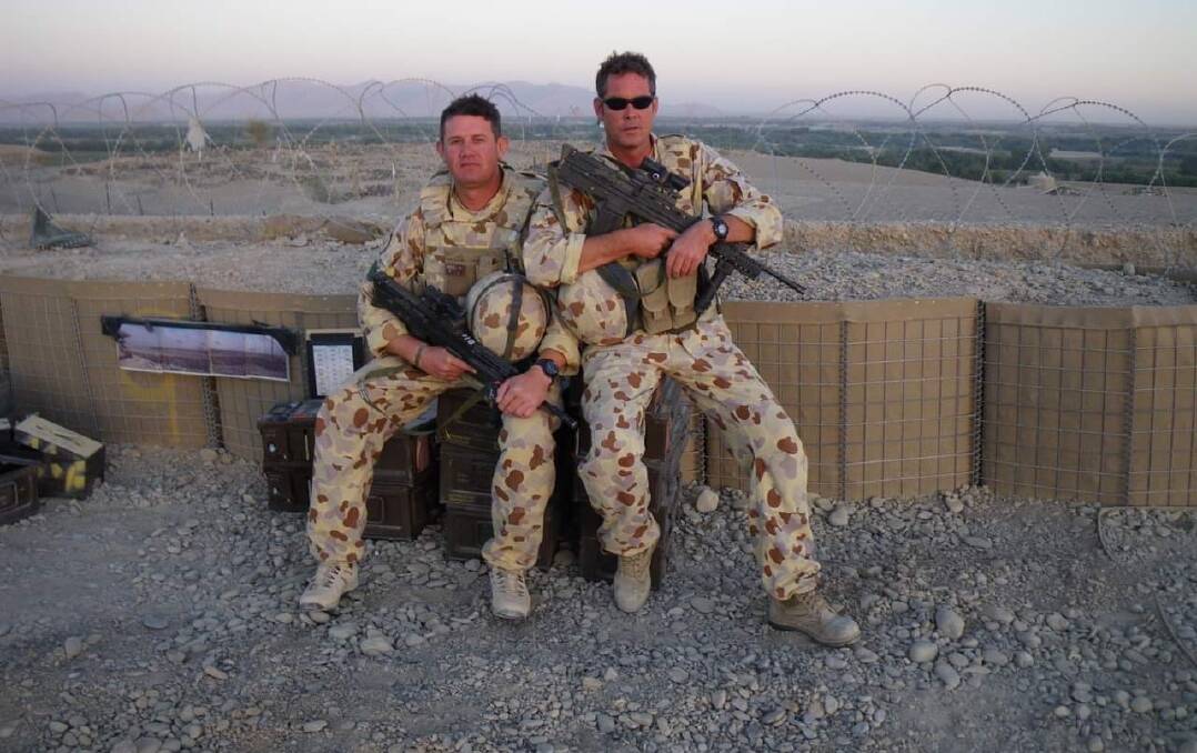 Warrant Officer Shaun Graham with a fellow soldier somewhere in the Middle East. Picture Supplied