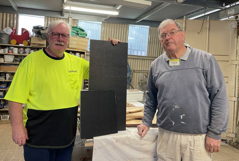 Dubbo Community Men's Shed Secretary John Gibson (left) holds up formply used by Philip Green and Robert Ferguson (not pictured) to build breeding boxes for Taronga zoo. Picture by Bageshri Savyasachi