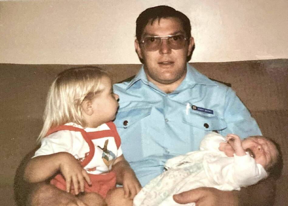 A young Bob Whitney with his two daughters. Picture supplied by NSW Ambulance. 