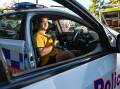 Farrer Memorial Agricultural High School student Zak Power tries on a police patrol car for size, during the launch of the You Should Be a Cop in Your Hometown and Youth Program in Tamworth. Picture by Gareth Gardner