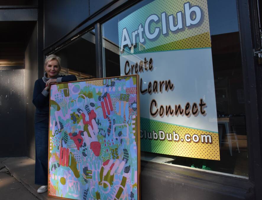 Artist Gill Pedrana with one of her paintings in front of the Art Club. Picture by Ciara Bastow 