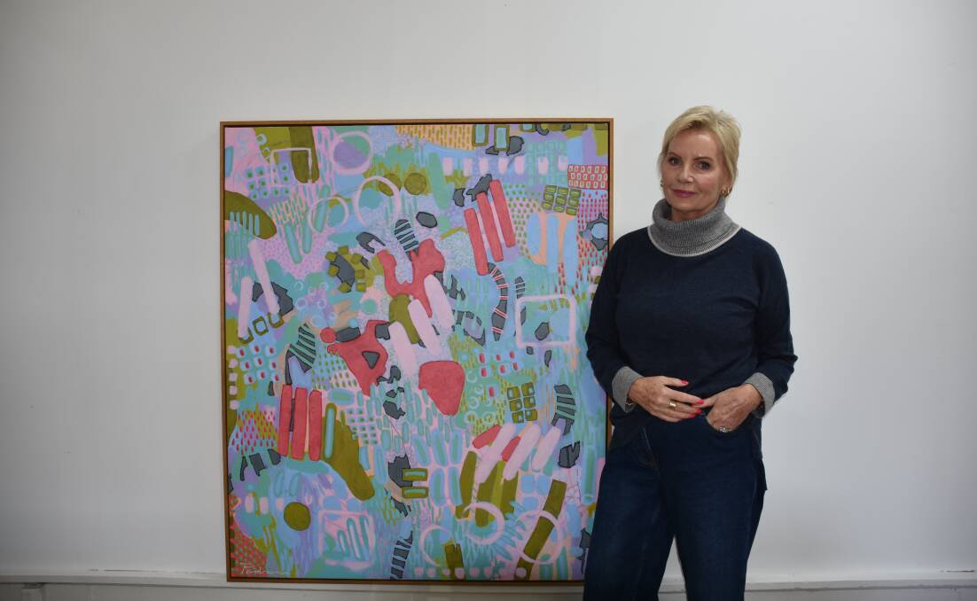 Artist Gill Pedrana with one of her paintings inside the Art Club. Picture by Ciara Bastow 