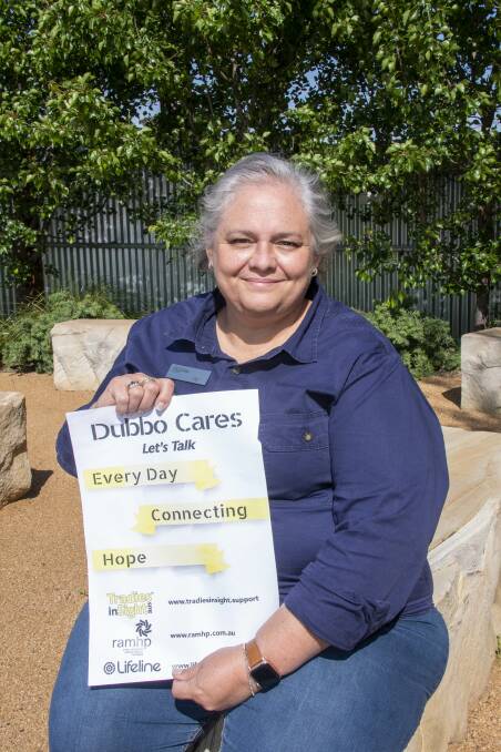 Jo Efoti holds up a Dubbo Cares sign, inviting residents to look after their mental health. Picture by Belinda Soole. 