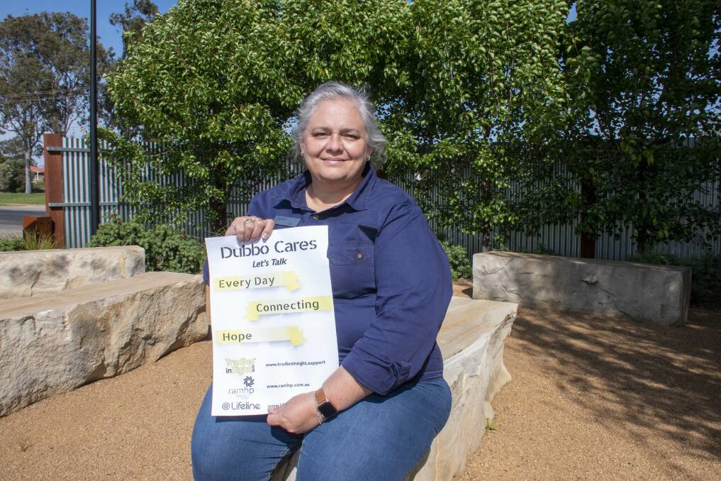 Jo Efoti holds up a Dubbo Cares sign, inviting residents to look after their mental health. Picture by Belinda Soole 