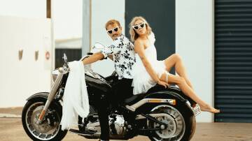 Tom and Madison Ayre sitting on a motorcycle enjoying their pre-wedding bliss. 