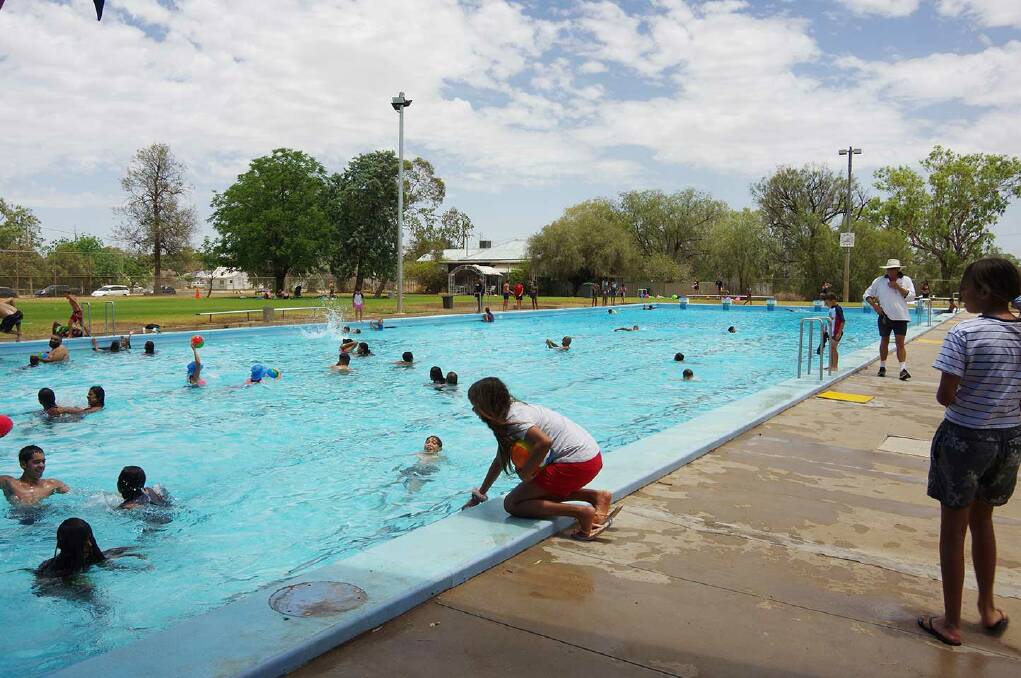 Walgett Memorial Swimming Pool with lots of young kids swimming and playing. Picture by Dharriwaa Elders Group. 