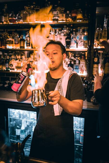The Establishment Bar's mixologist Ashij Shah working on a flaming hot cocktail Picture: Supplied 