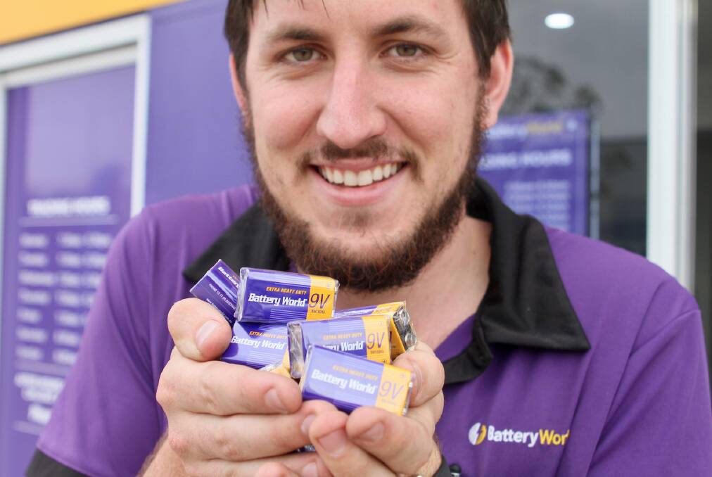 RECYCLE: Battery World staffer Matthew Owens is ready to hand out batteries. Photo: CONTRIBUTED