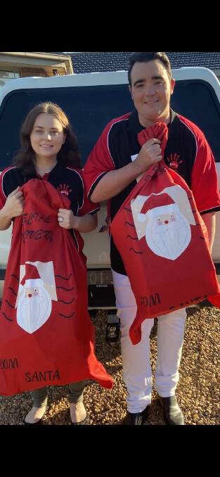 SANTA SACK: Beccy and Jason Owen with their sacks. Picture: CONTRIBUTED. 