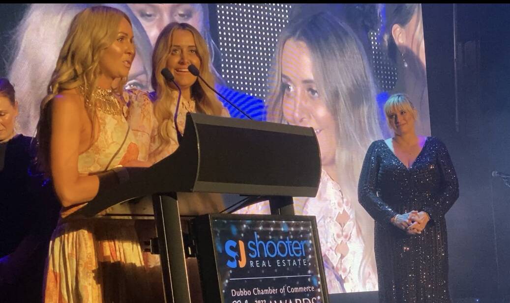 Sisters Heidi Nichols and Kim Scott took to the stage to accept the 2022 Gold Rhino award on Friday night. Picture by Belinda Soole