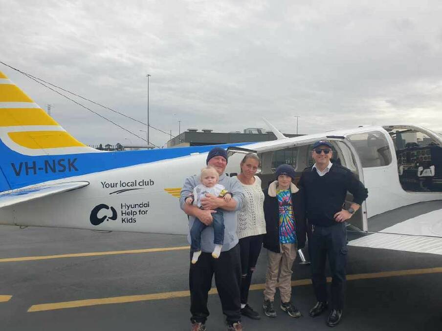 P.J's dad Bruce holding baby P.J, with P.J's mum Amanda and brother Billy Jack, and Little Wings pilot Edward. Picture supplied