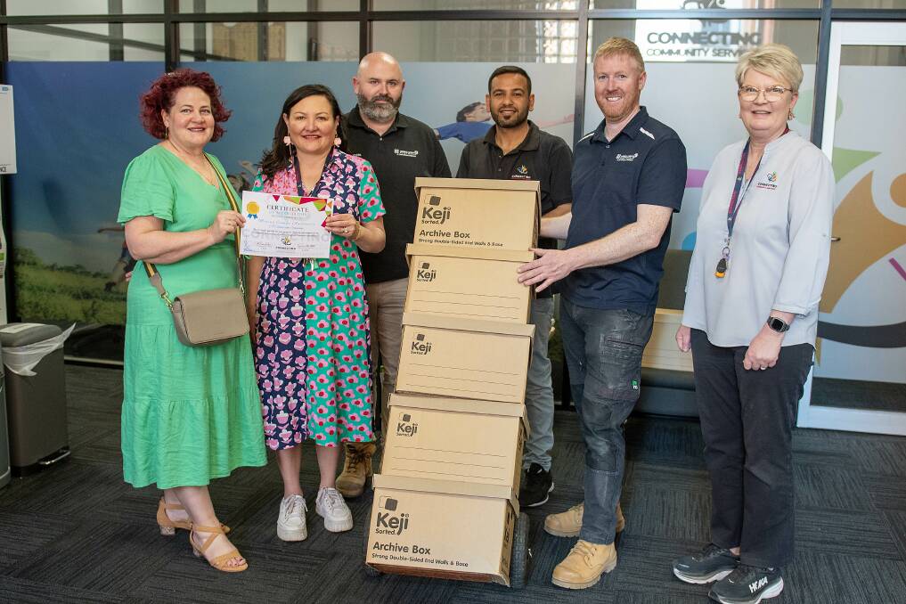 Melissa Britnell, Michelle Redden, Kevin McManus, Khaled Taleb, Alan Kelly and Christina Adams at Connecting Community Services as food hampers are donated by Mining Camps Australia. Picture by Belinda Soole