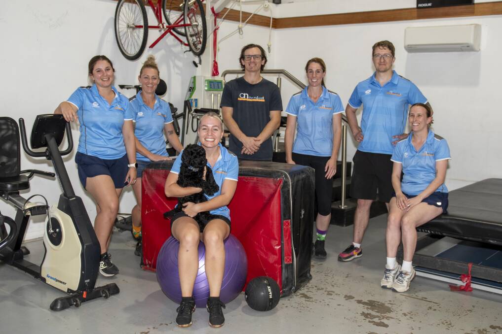Nic Grose (second left) with the team at Active - On The Move Rehab, including Barry the eight-week-old therapy dog. Picture by Belinda Soole