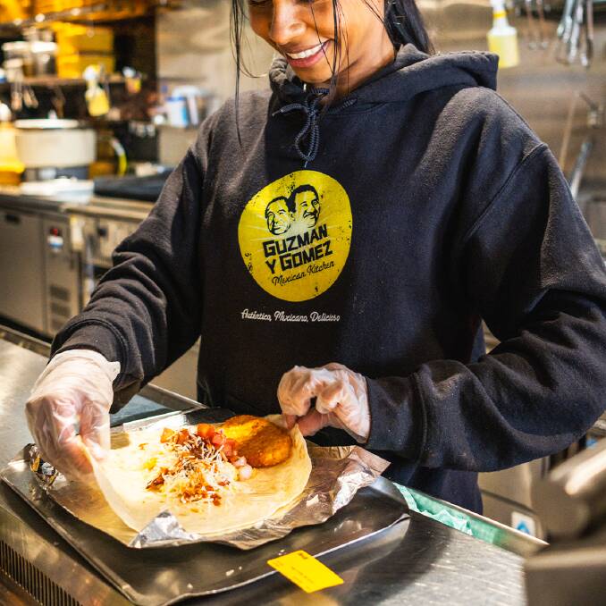 A generic picture of a Guzman Y Gomez staff member rolling a burrito. Picture supplied