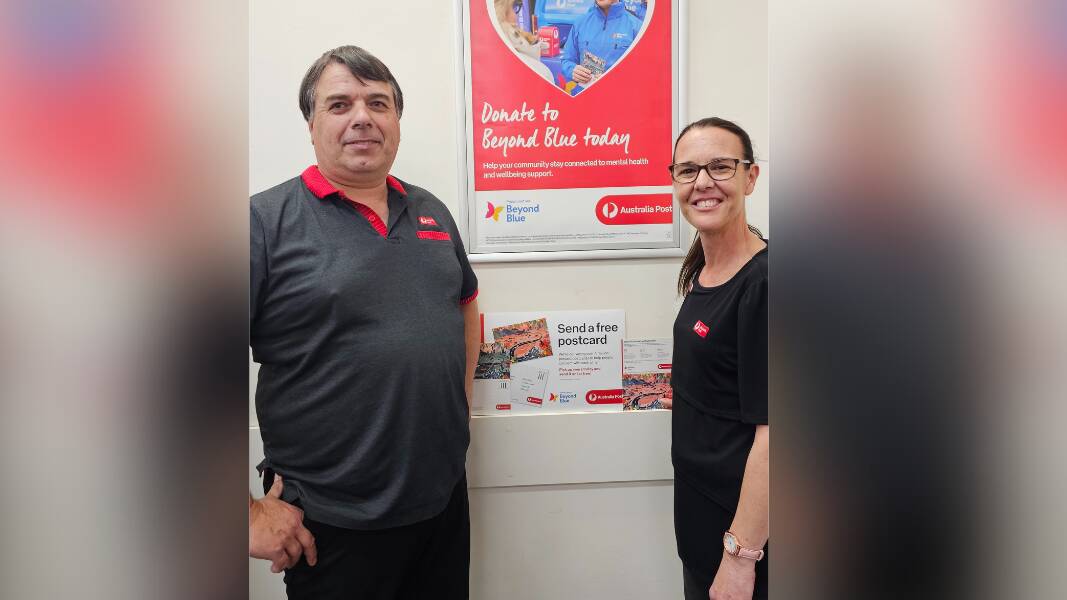 Rod Boatwood and Shanee Smith with free postcards at Dubbo post office. Picture supplied