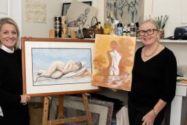 Jayne Hutty and Lyndal McRae of Fresh Arts Inc with some of the artworks which will feature in the Not Nude Enough exhibition at The Establishment Bar Dubbo. Picture by Belinda Soole