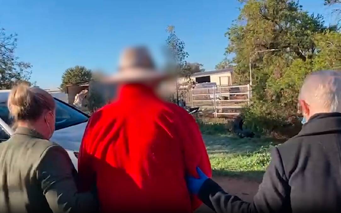 A still taken from footage of the arrest of a 63-year-old man charged with more than 70 historical sex offences. Picture by NSW Police