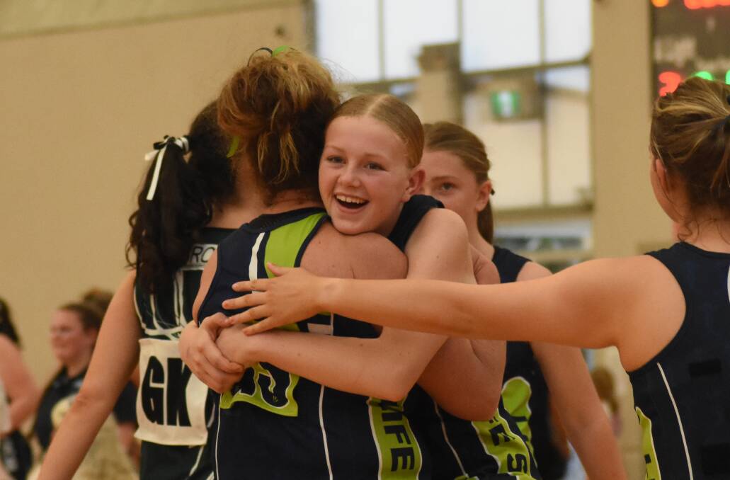Rori McDonell hugs her mum Ni McDonell after Life Studio came out victorious in their division three Orange Netball Association grand final. Picture by Riley Krause