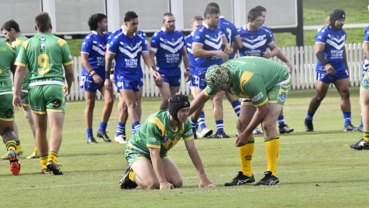 Cam Jones checks on Liam Wilson after the youngster's error led to a Macquarie try. Picture by Riley Krause.
