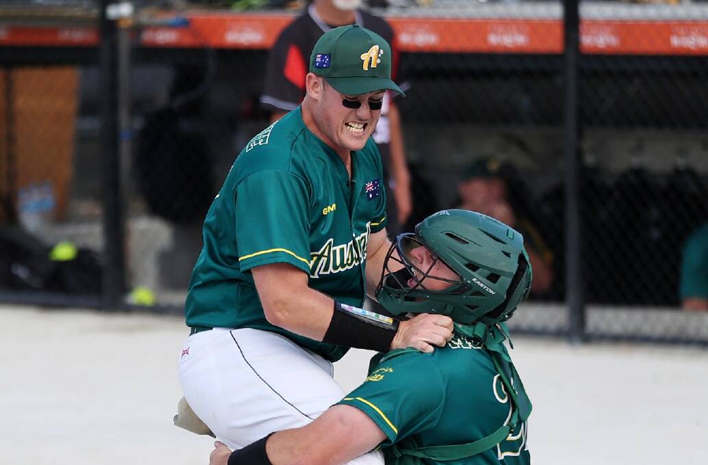 Jack Besgrove celebrates with his catcher after winning the 2022 men's softball world championship. Picture by WBSC Softball World Cups
