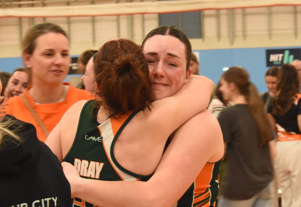 A teary-eyed Caitlyn Harvey hugs captain Tegan Dray after Orange City's 14 point victory. Picture by Riley Krause