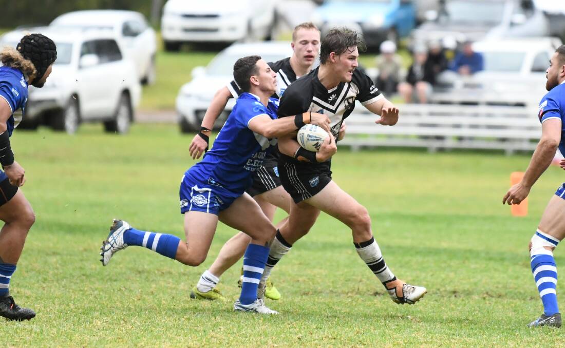 Randel Dowling of Macquarie attempts to bring down Forbes' Charlie Lennon on Sunday. Picture by Renee Powell
