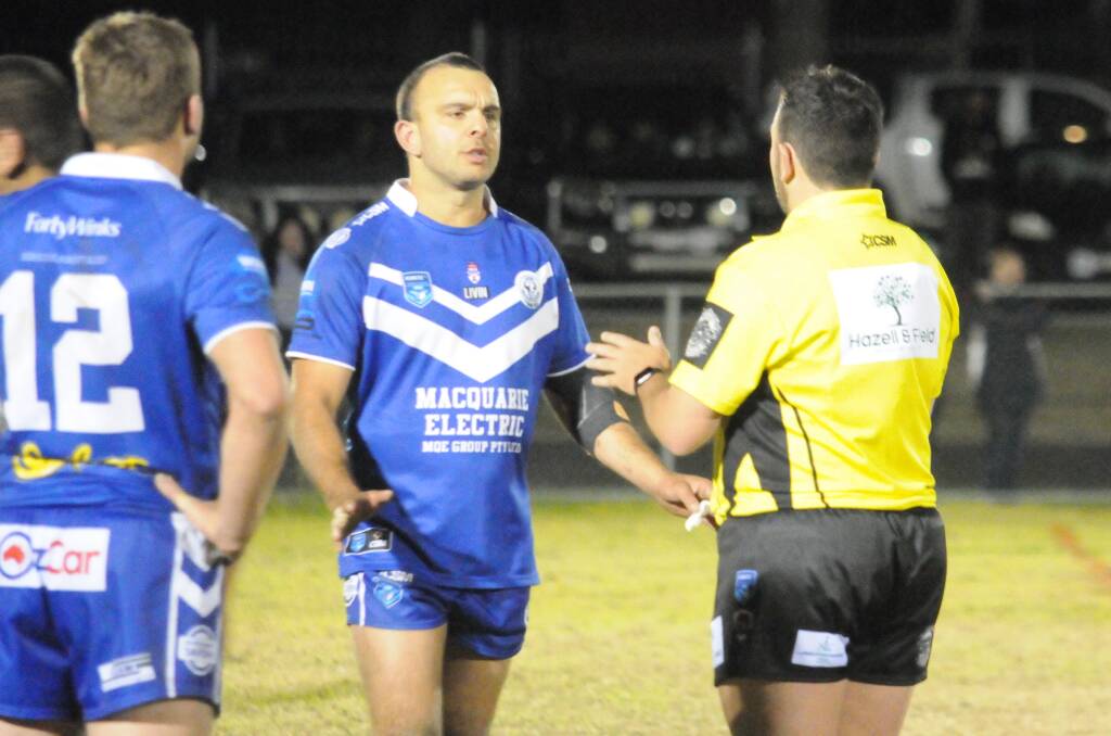 Macquarie Alex Ronayne talks with referee Nathan Blachard during the thriller at Kennard Park on Saturday night. Picture by Nick Guthrie