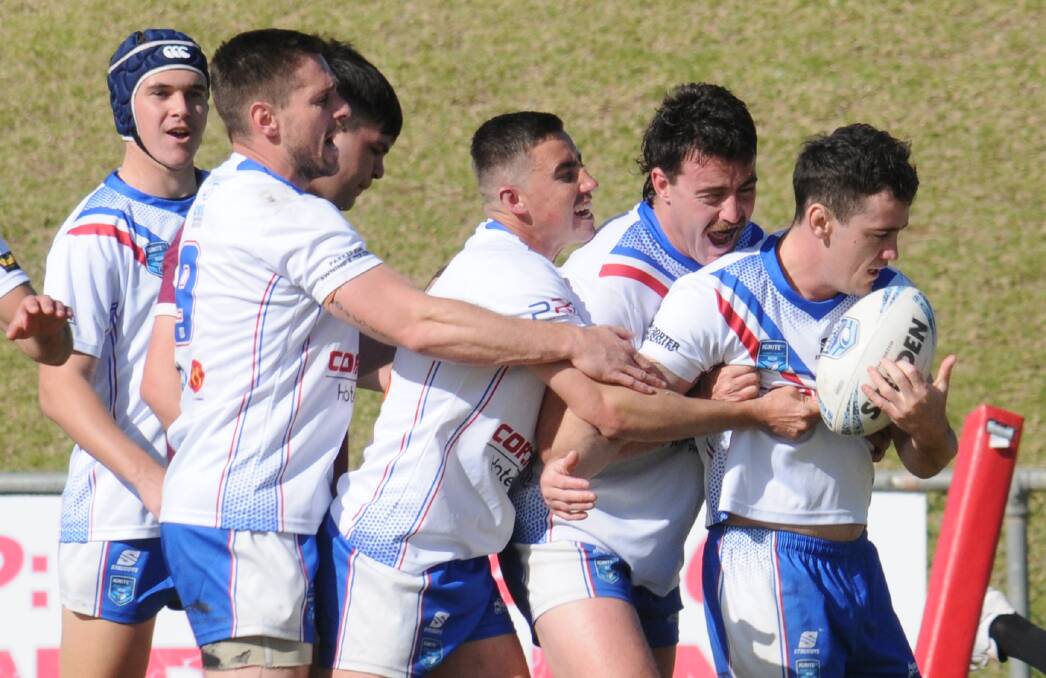 Will Wardle (second from right) celebrates with teammates after captain-coach Chad Porter's try on Sunday. Picture by Nick Guthrie