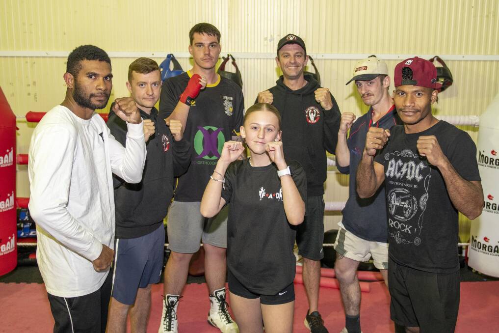 Trainer and promoter Chris Hallford (back, third from right) with Fighting Arts Dubbo athletes (from left) Tony Oaike, Luke Prentice, Matt Maher, Edward Foran, Camillus Kavo and Ericka Keizer (front). Picture by Belinda Soole