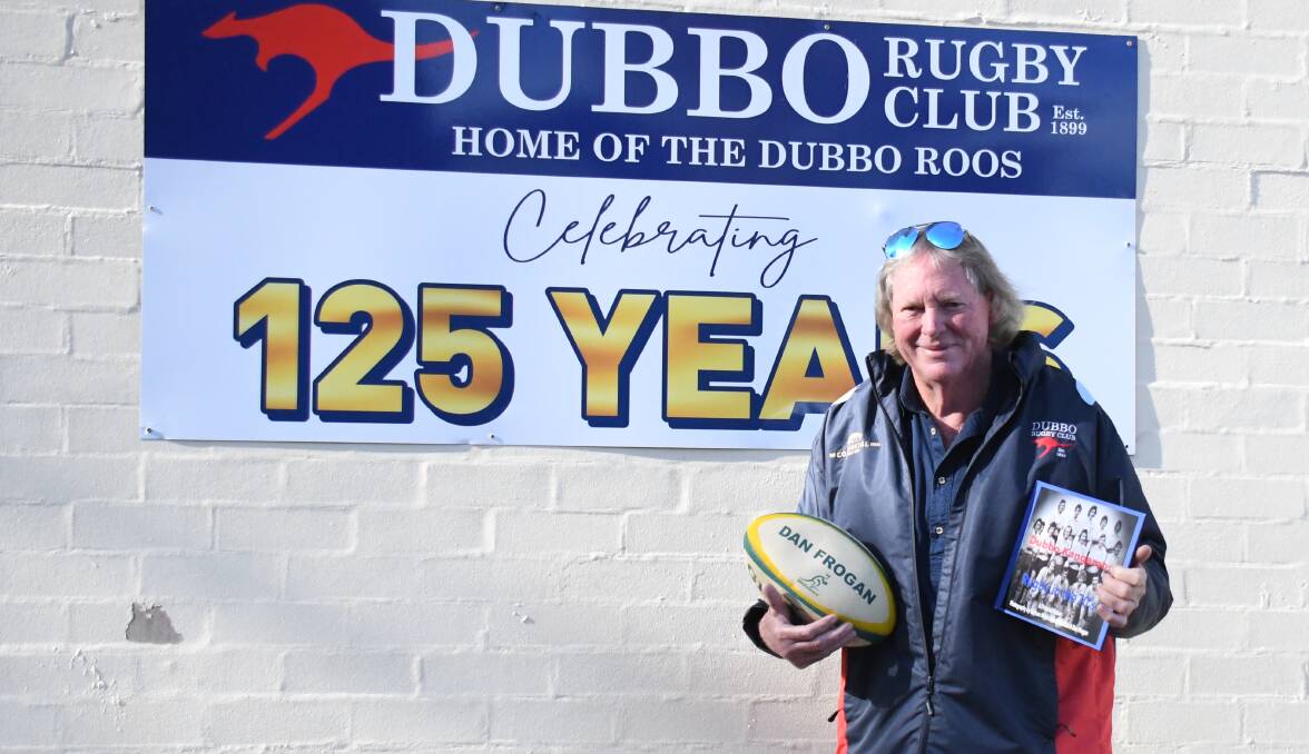 Graham Mackie with a book of photos he put together celebrating the Dubbo Rugby Club in the 1970s. Picture by Nick Guthrie