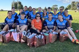 Alissa West (centre) with the Macquarie Raidettes and the donated dignity bags. Picture supplied
