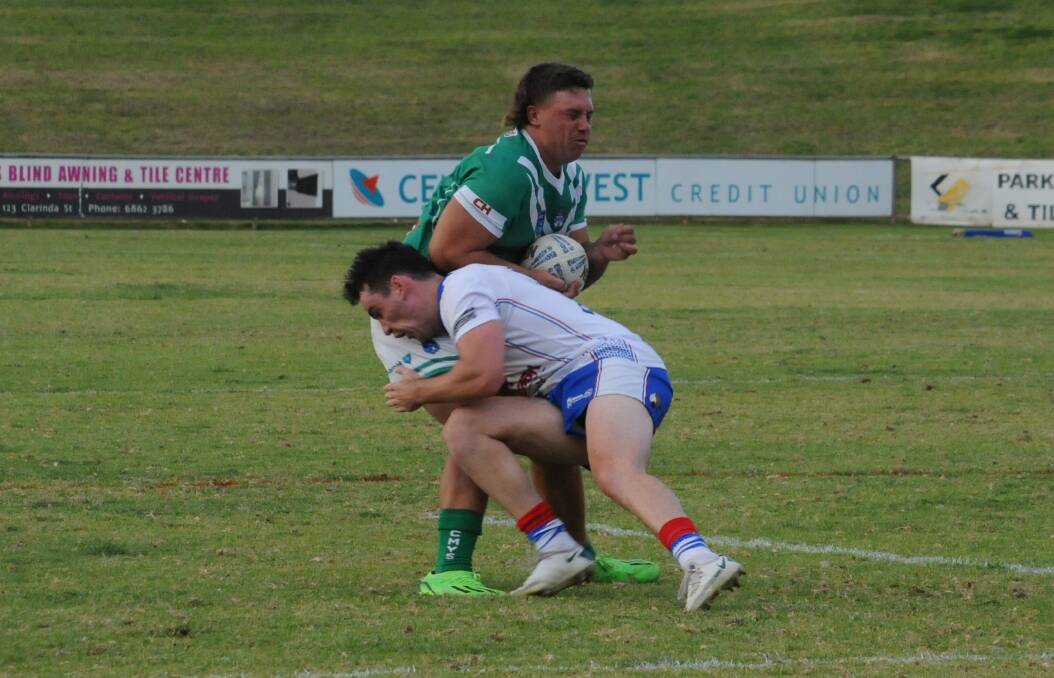 Jayden Merritt is stopped by Parkes' Chad Porter during Saturday's match at Pioneer Oval. Picture by Nick Guthrie
