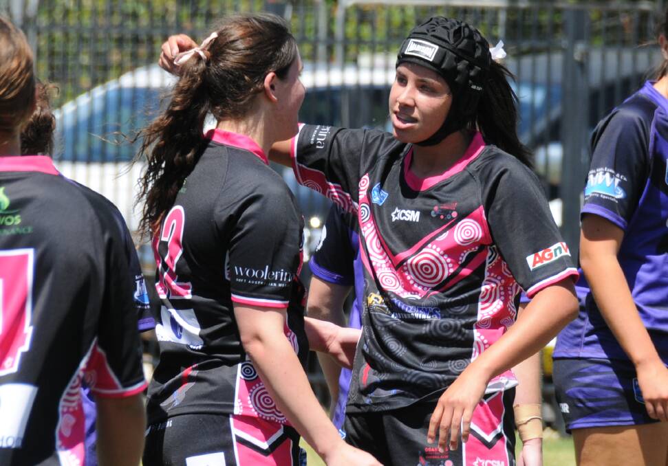 Saxbii Shaw is congratulated after scoring a try for the Goannas under 18s on Sunday. She was one of few players in that age group wearing headgear on Sunday. Picture by Nick Guthrie