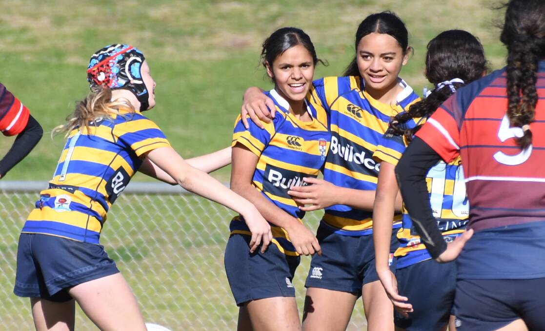 Tanaya Smith (centre) was all smiles after scoring one of her two tries in the grand final. Picture by Nick Guthrie