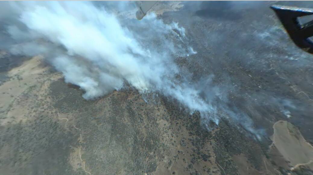 Out-of-control: An aerial view of the fire burning in the Wuuluman district between Mudgee and Wellington. Authorities upgraded the blaze to 'watch and act' on Friday as conditions deteriorated. Photo contributed.