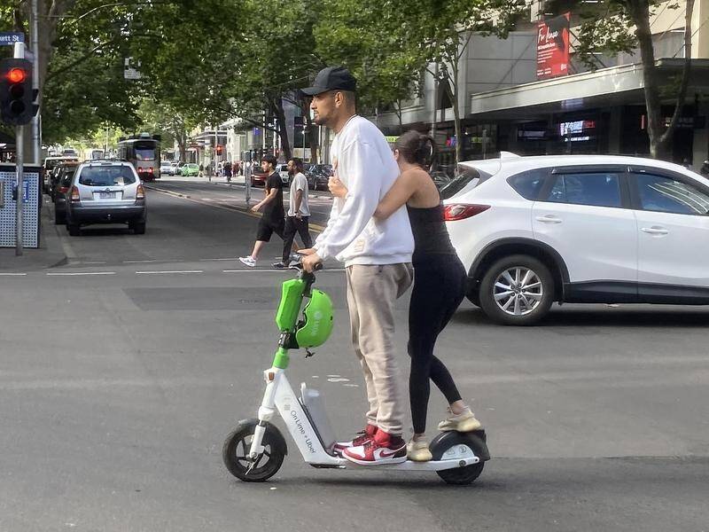 Tennis star Nick Kyrgios could be fined for riding an e-scooter without a helmet in Melbourne. (James Ross/AAP PHOTOS)